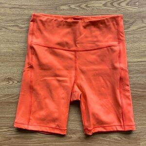 ATHLETA ultimate stash pocket 7 inch short in orange size S
